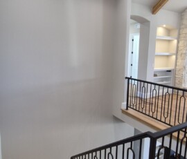 Architectural accent and safety lighting. Installation of low-profile, recessed LED stair riser lights for night-time safety, matched with perfectly spaced directional ceiling downlights to highlight the modern architectural lines.