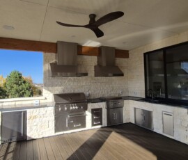 Elite outdoor kitchen build featuring weatherproof flush-mount ceiling spotlights and under-counter accent lighting.